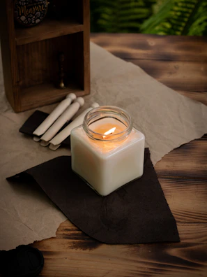 A cozy workspace with colorful candle supplies scattered invitingly on a bright cloth.
