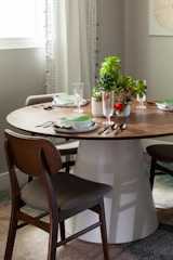 A stylish dining set made of rich wood, set for a family meal with soft natural light.