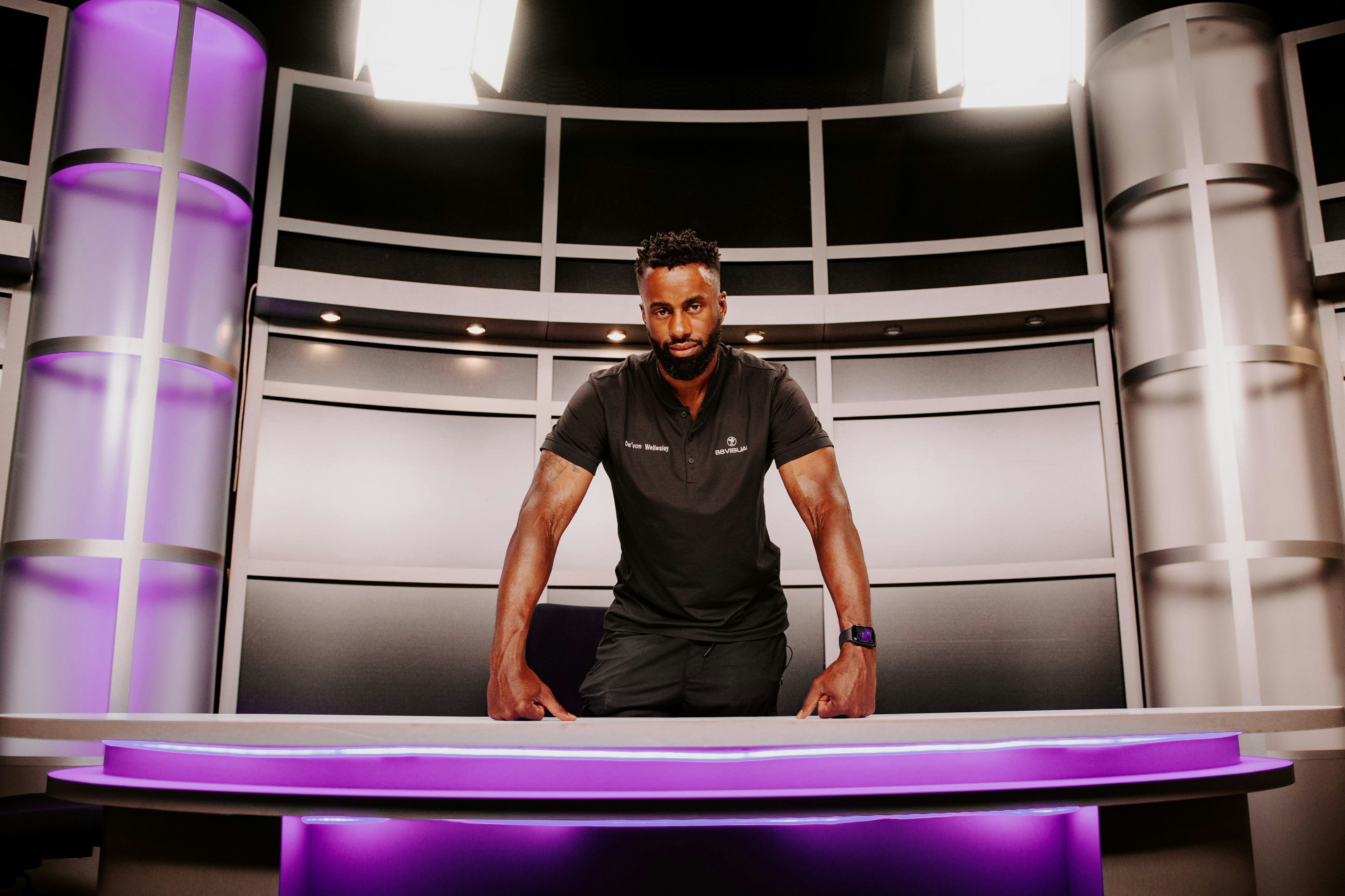 a man standing in front of a purple table