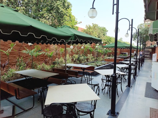 A vibrant outdoor seating area filled with plants and patrons.