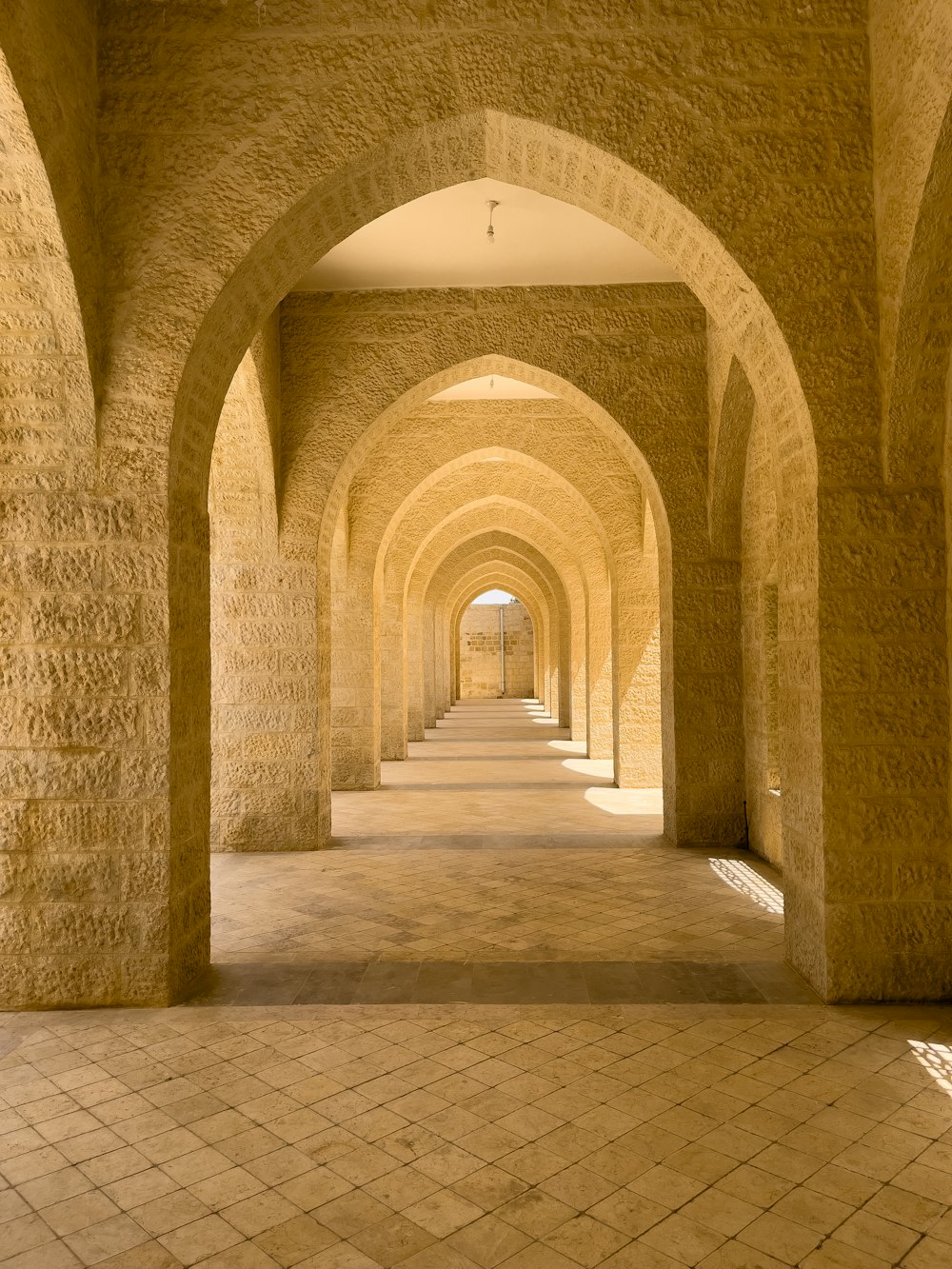 a very long hallway with a bunch of arches