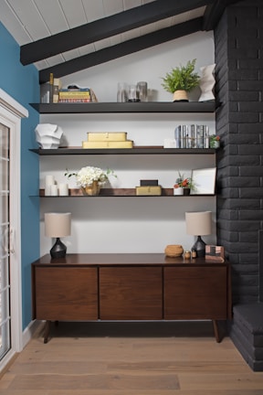 A stylish wooden credenza with clean lines, accessorized with vintage decor pieces.