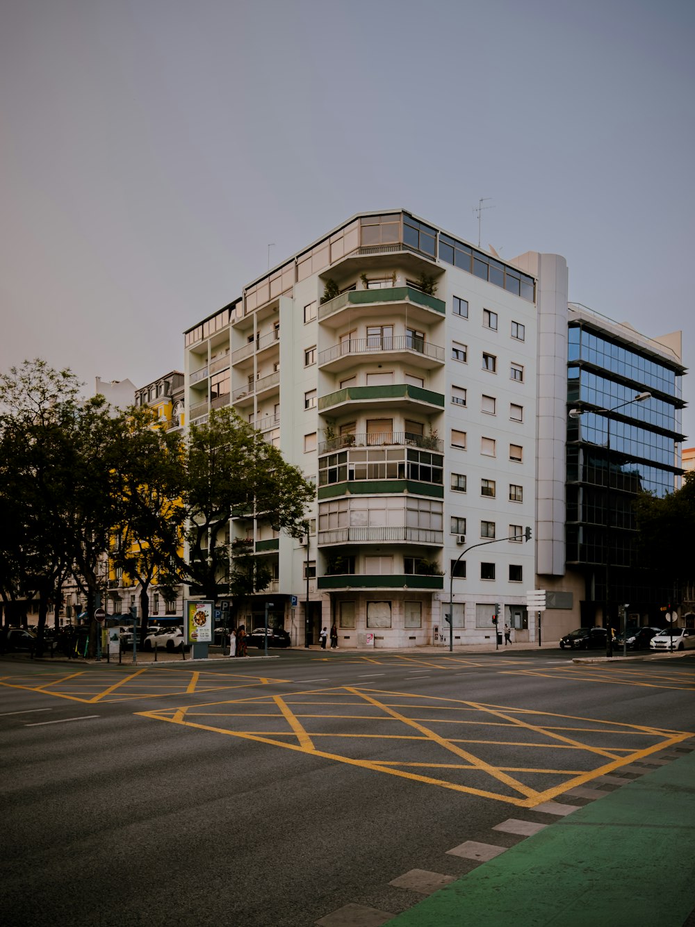 a large white building sitting on the side of a road