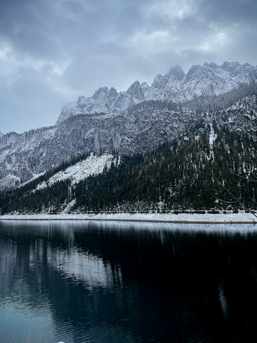 a large body of water surrounded by snow covered mountains