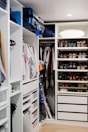 A spacious closet with hangers and extra bedding.