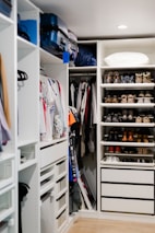 A bright, airy closet showcasing various storage boxes neatly stacked and labeled.