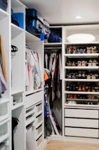 Close-up of neatly arranged closet with labeled storage boxes.