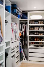 a walk in closet filled with lots of shoes