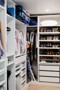a walk in closet filled with lots of shoes