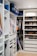 A beautifully organized modern closet featuring custom wooden shelves and drawers.