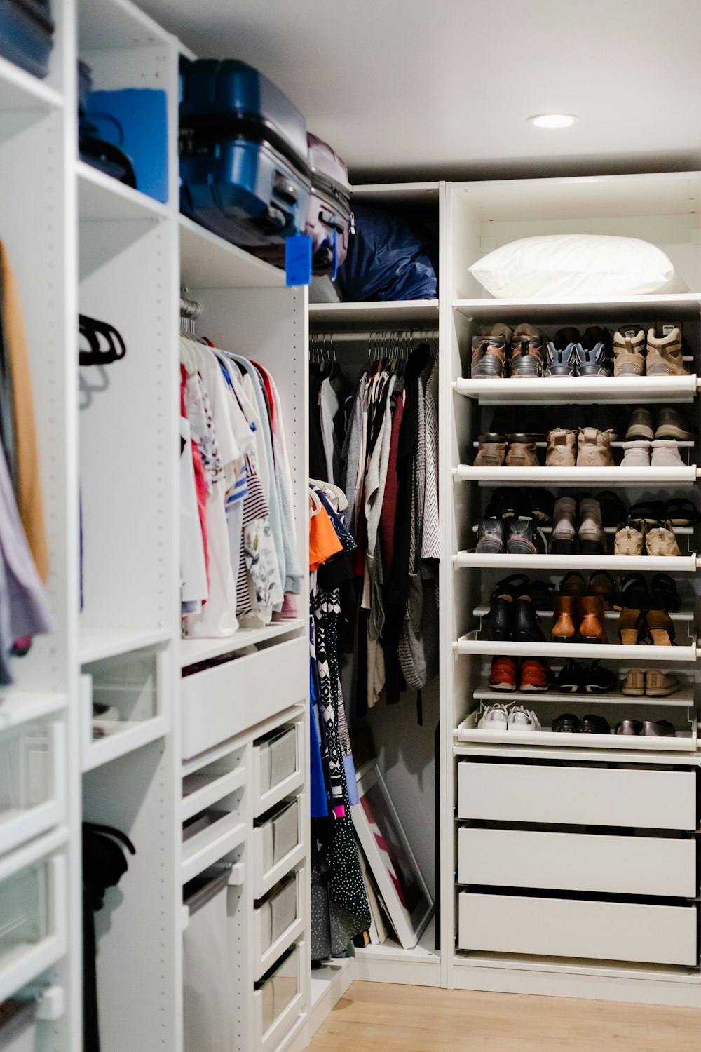 a walk in closet filled with lots of shoes