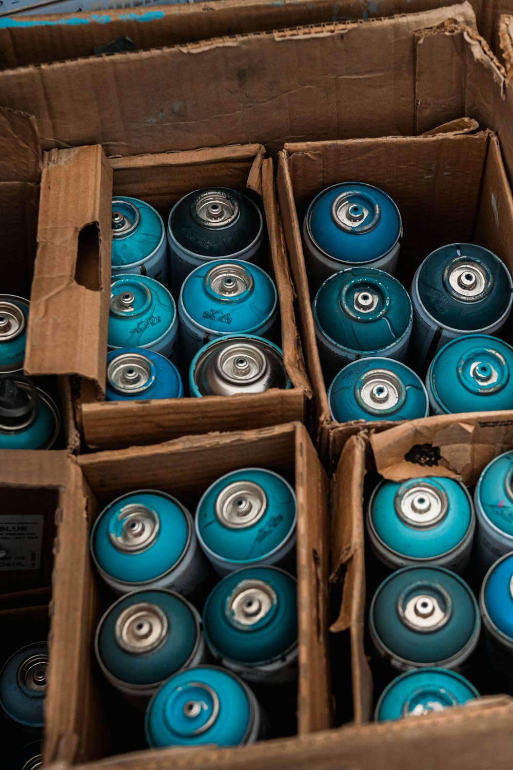 a box filled with lots of blue cans