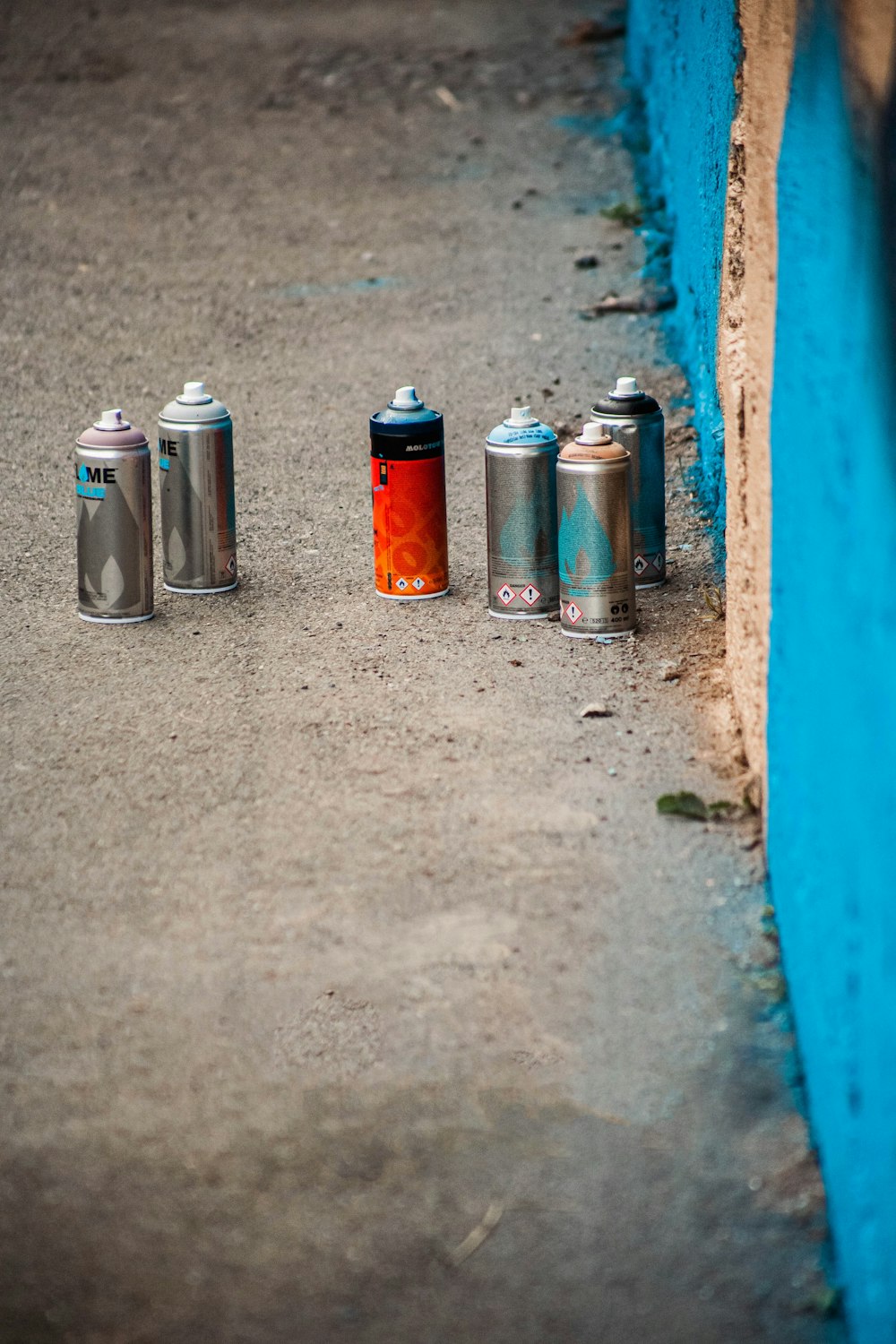 a group of cans sitting on the side of a road