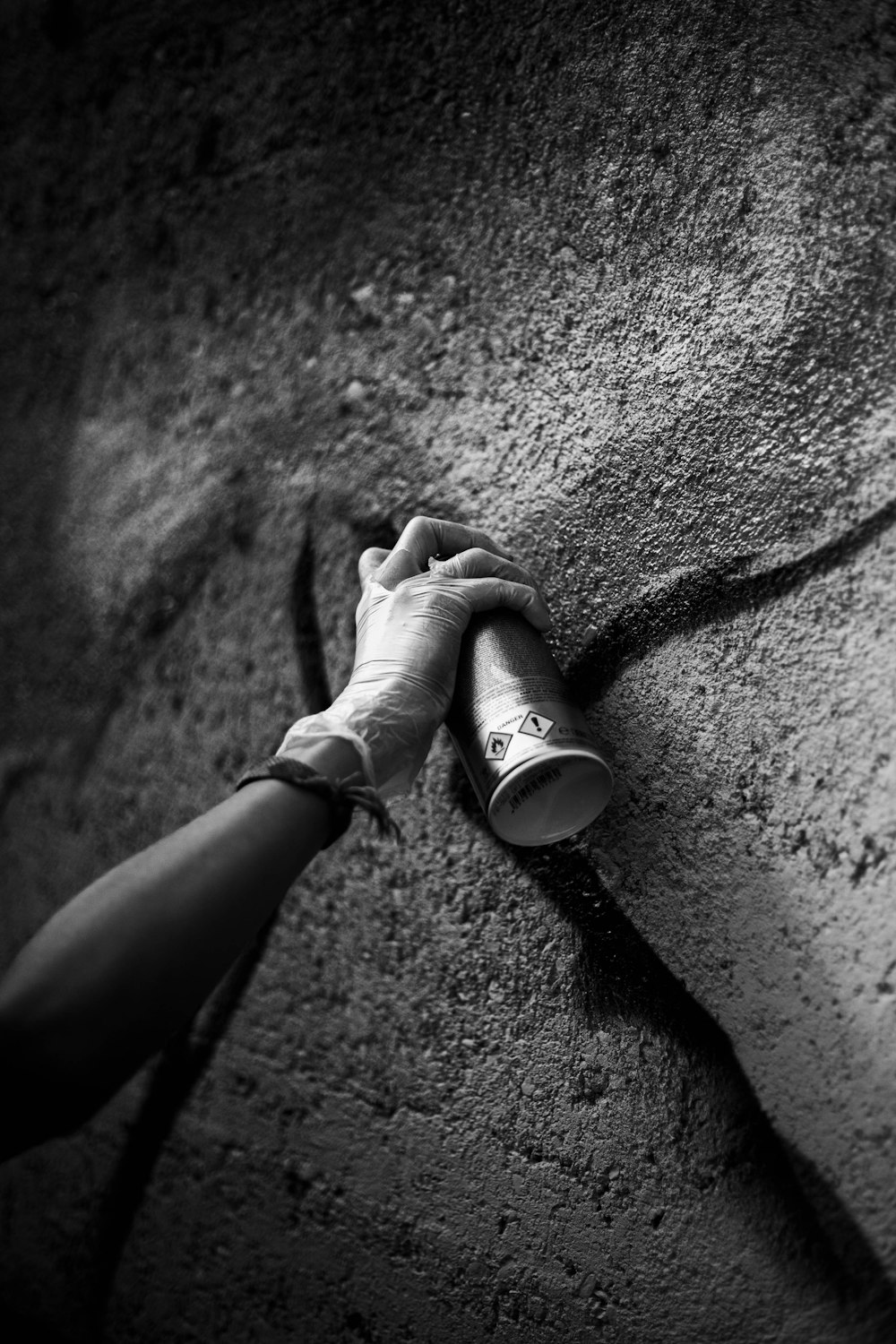 a black and white photo of a person holding a flashlight