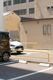 White and gray cars parked side by side ready for service in an urban environment.