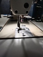 Close-up of sewing tools and materials on a workspace.
