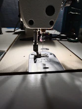 Close-up of detailed sewing patterns and fabric swatches on a worktable.