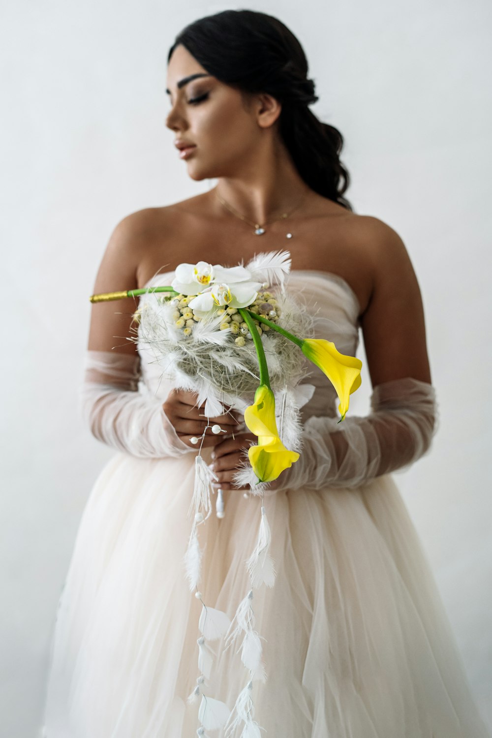 a woman in a wedding dress holding a bouquet of flowers