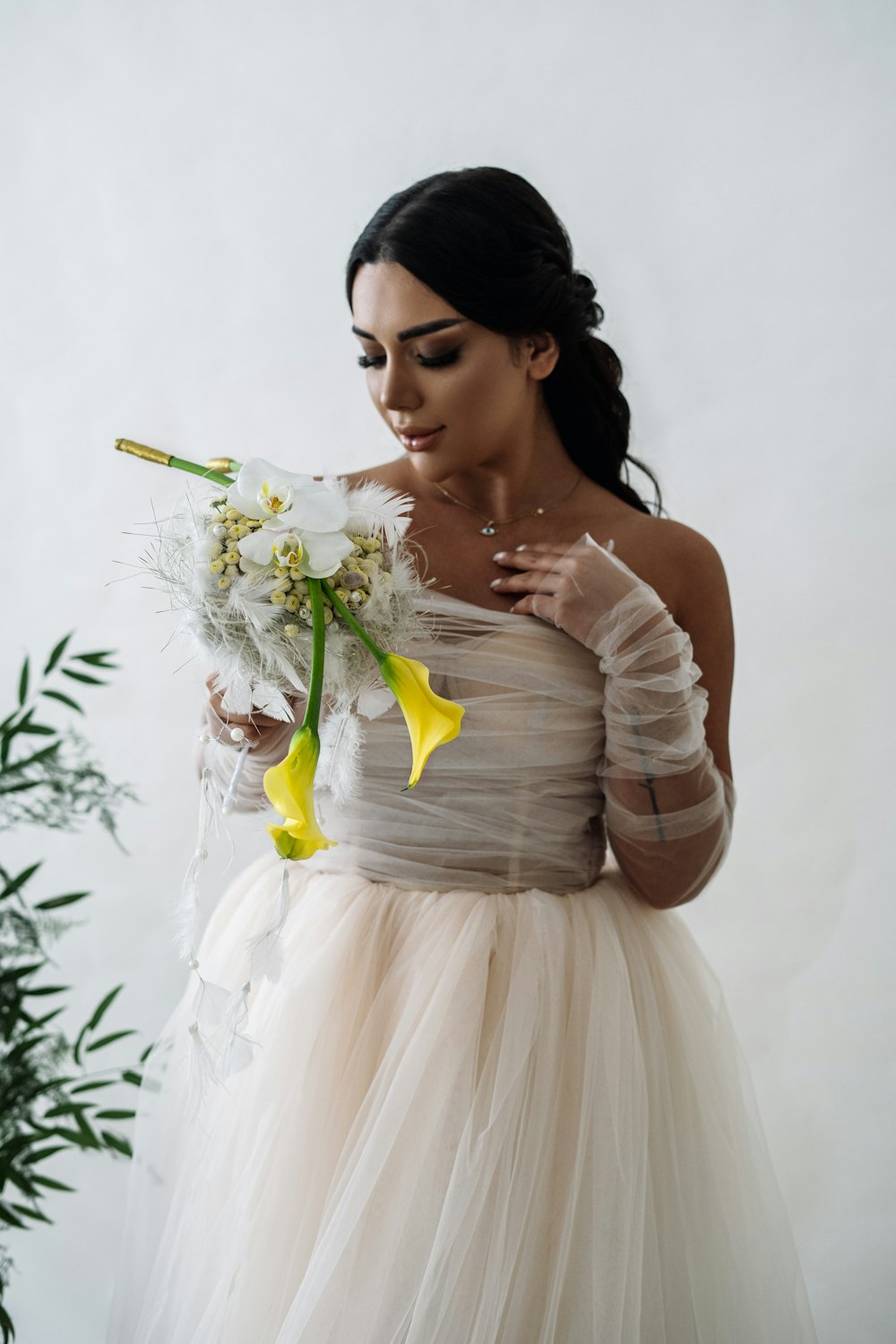 a woman in a dress holding a bouquet of flowers