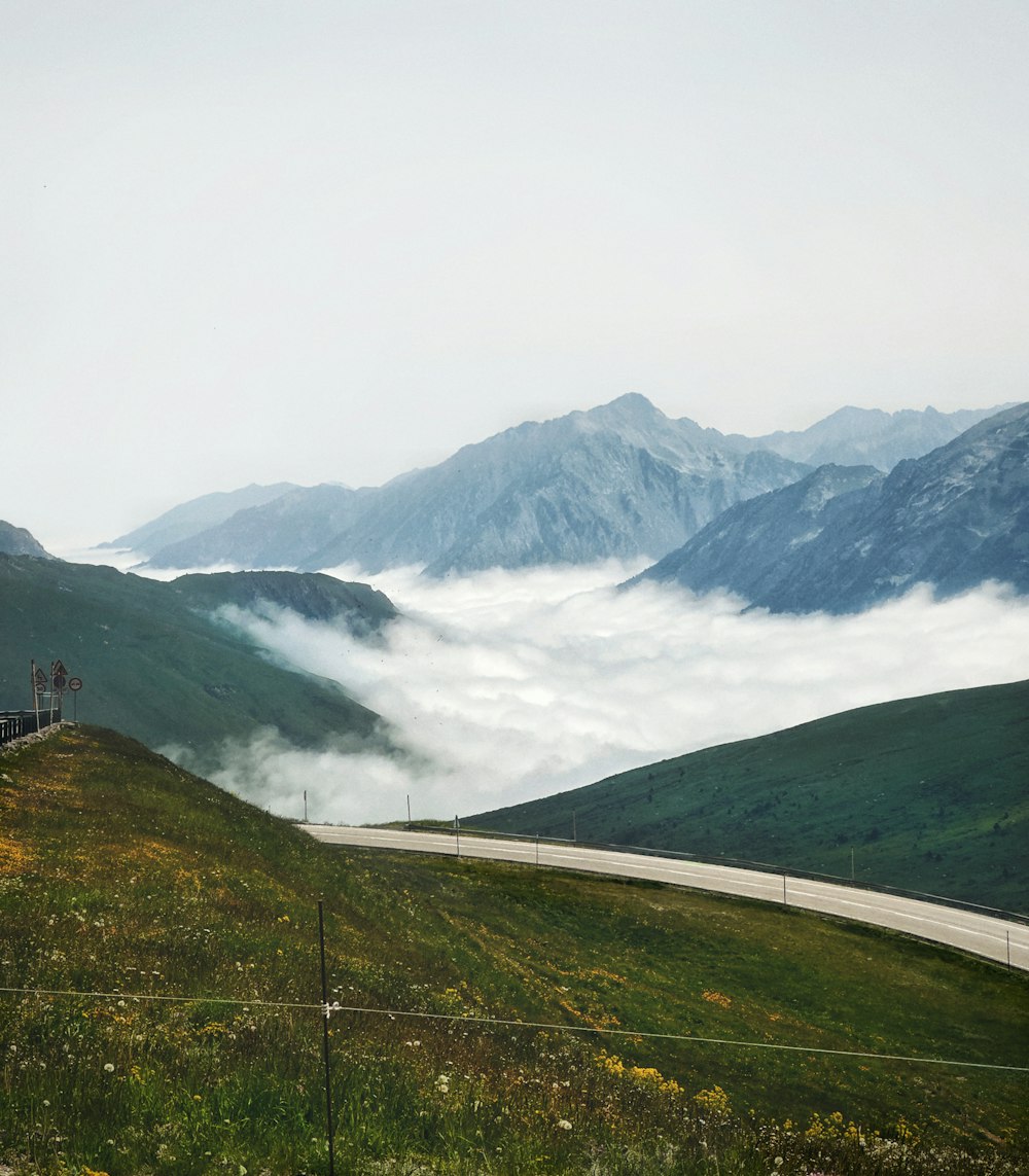 a scenic view of a mountain with a road going through it