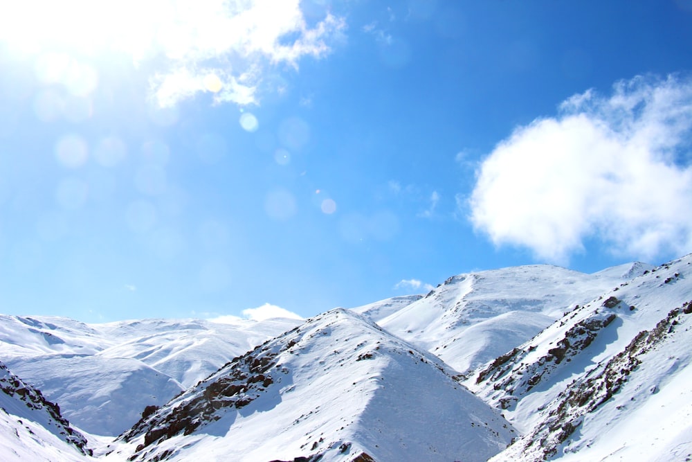 a snowboarder is going down a snowy mountain