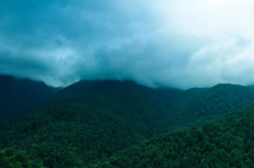 a view of a mountain range covered in clouds