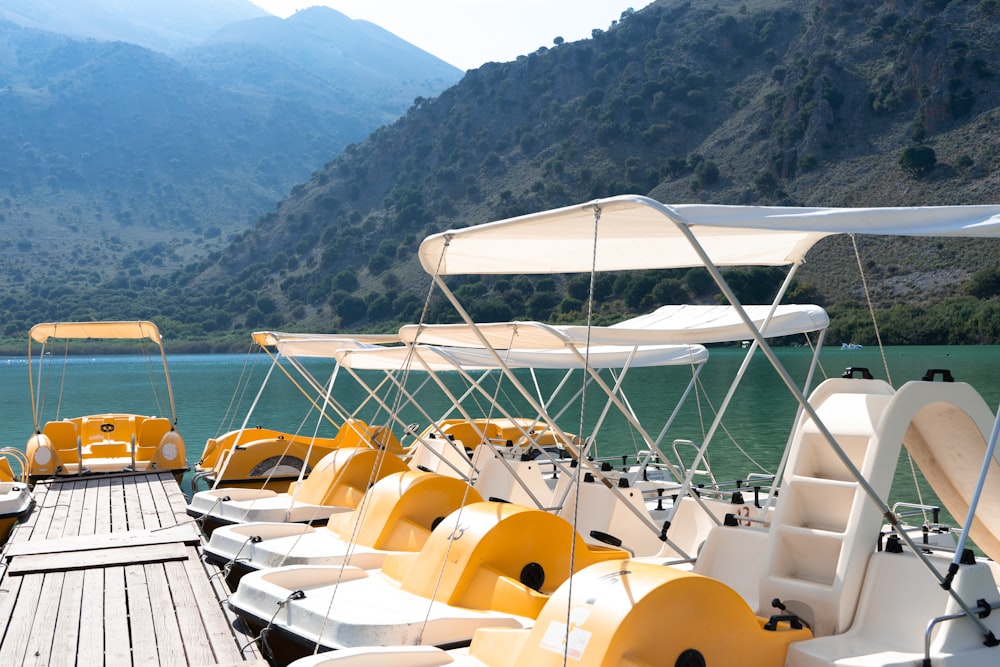 a row of yellow and white boats sitting next to each other