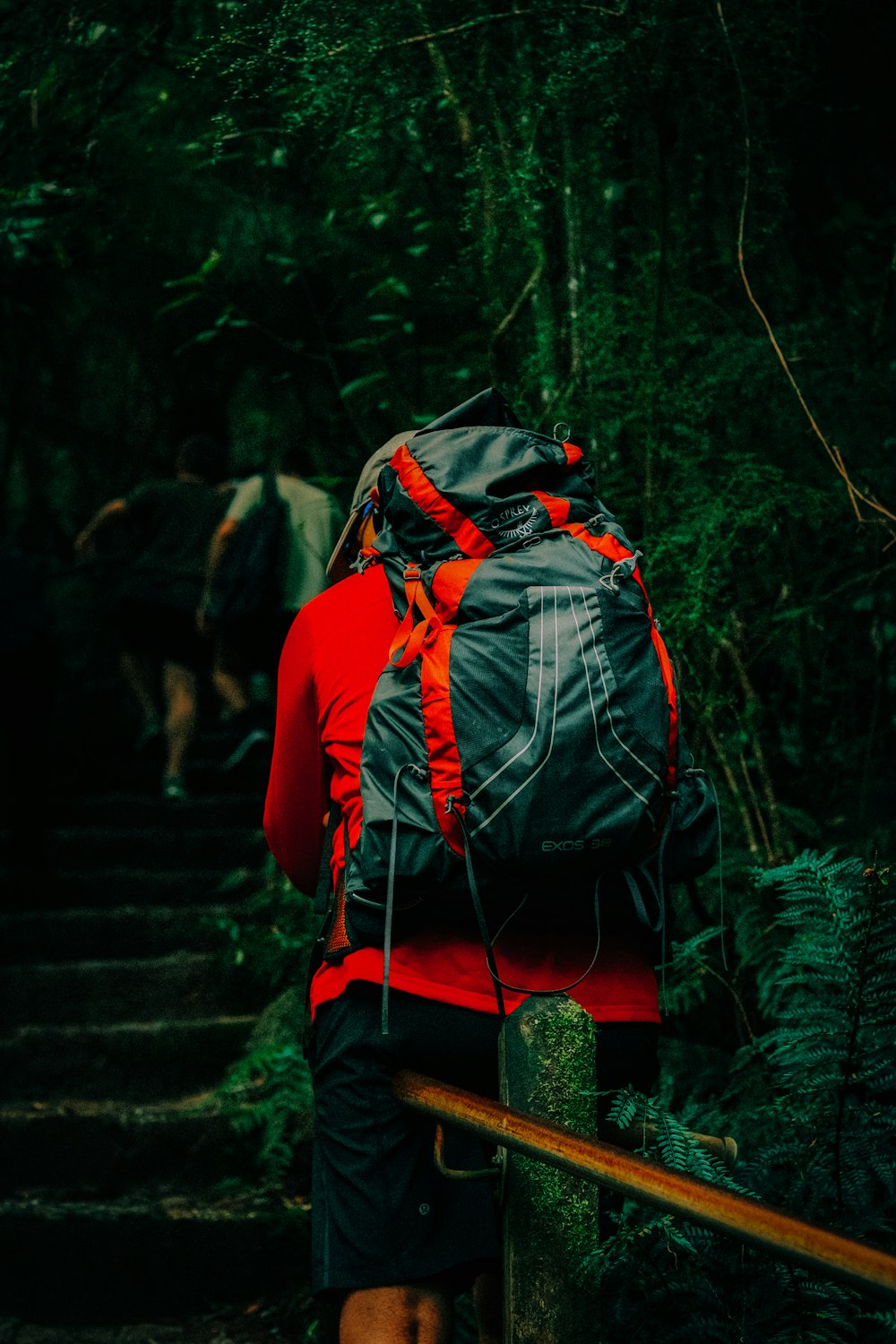 a man with a backpack walking up a set of stairs