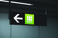 Green directional sign showing exit information on a highway.