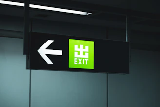 Green directional sign showing exit information on a highway.
