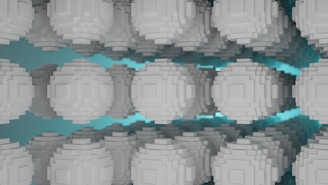 A series of gray pixelated spheres are arranged in a symmetrical pattern against a teal background, creating a sense of depth and repetition. The spheres have a blocky, voxel-like structure, resembling digital or abstract art.