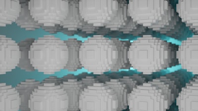 A series of gray pixelated spheres are arranged in a symmetrical pattern against a teal background, creating a sense of depth and repetition. The spheres have a blocky, voxel-like structure, resembling digital or abstract art.