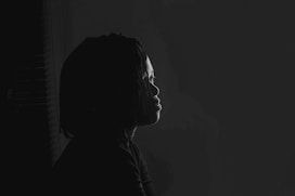 a black and white photo of a person in the dark