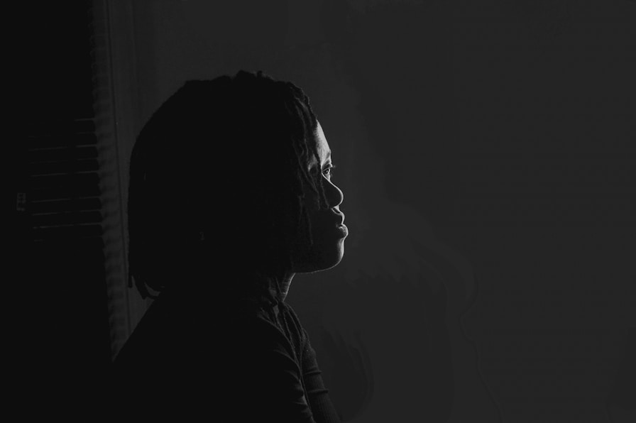 a black and white photo of a person in the dark