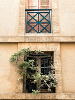 Exterior view of a house facade with newly installed windows and stone masonry.