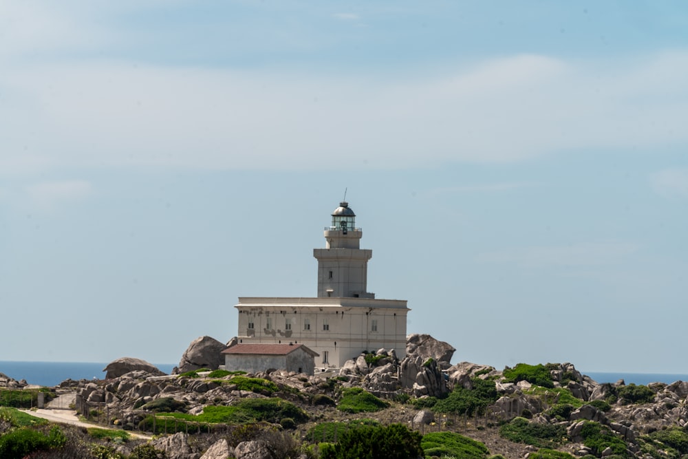 a lighthouse on top of a rocky outcropping