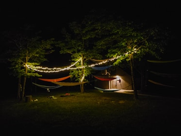 A communal outdoor area with hammocks and tiki torches, perfect for evening gatherings.