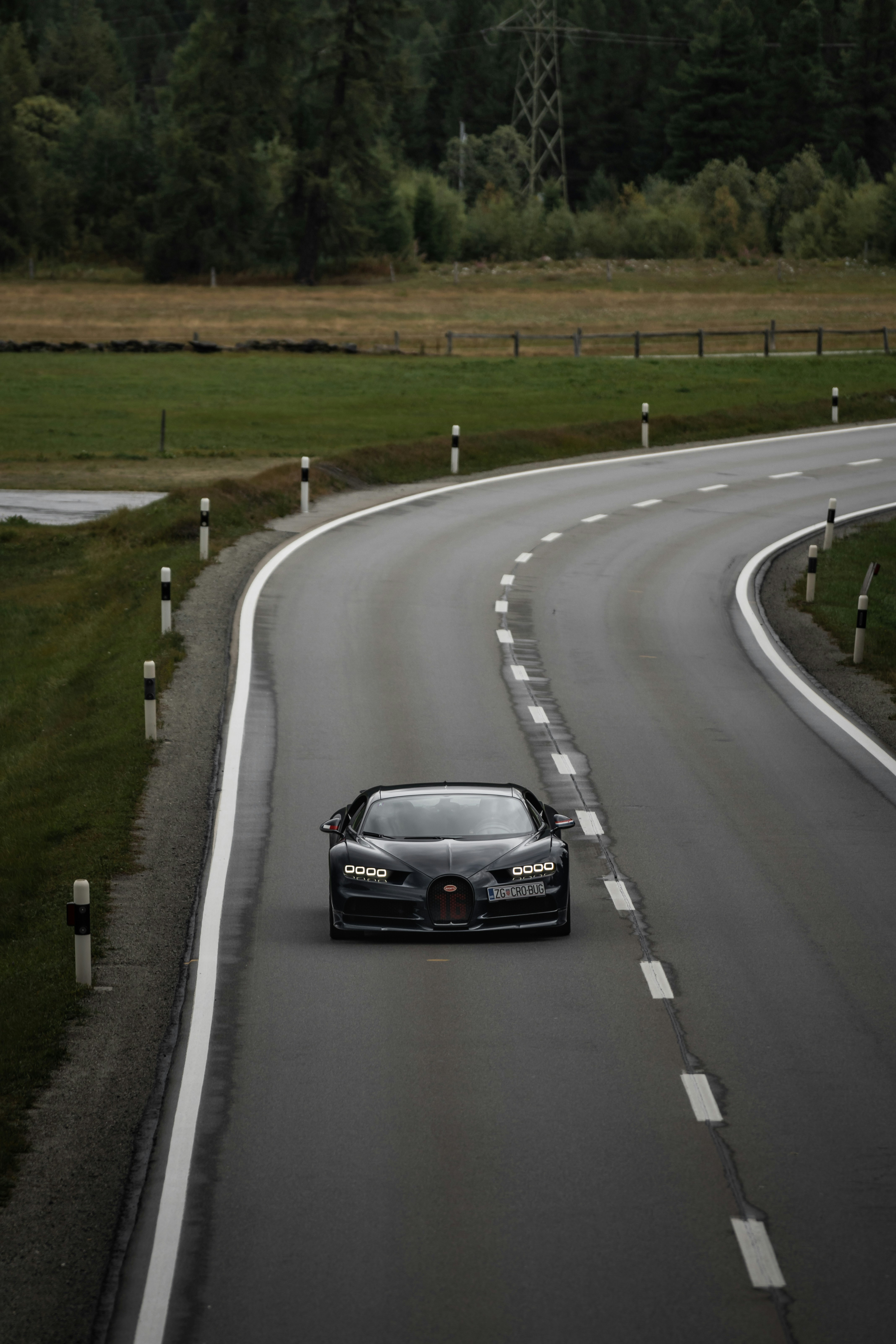 Bugatti driving on a wet road in the rain — demonstrating the all-weather capability of the quad-turbocharged W16 hypercar