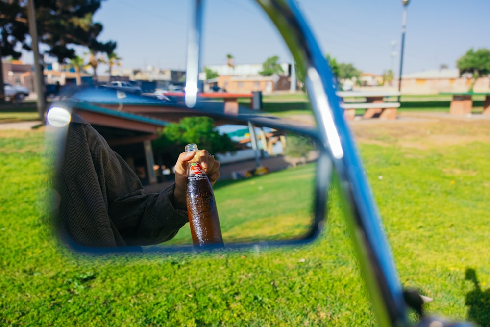 a person taking a picture of themselves in a rear view mirror