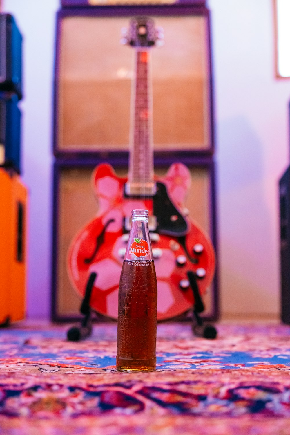 a bottle of soda sitting on top of a carpet
