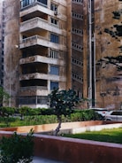 A property manager inspecting a well-maintained apartment building.