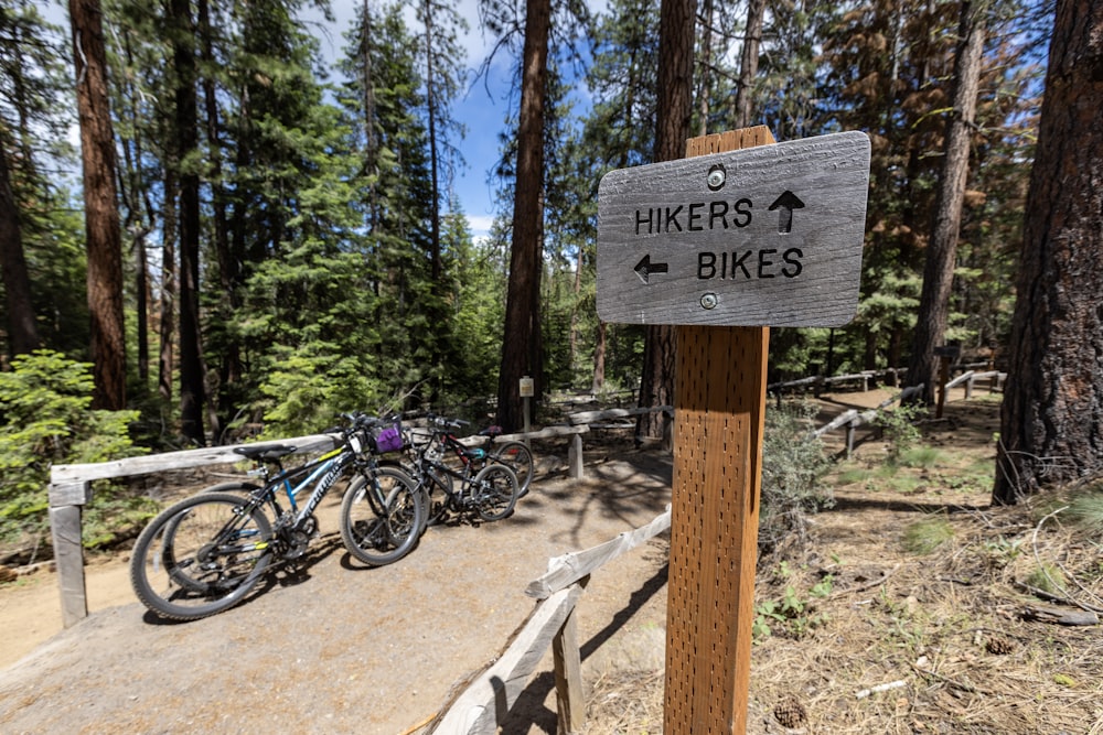 a wooden sign that says hikers at bikes