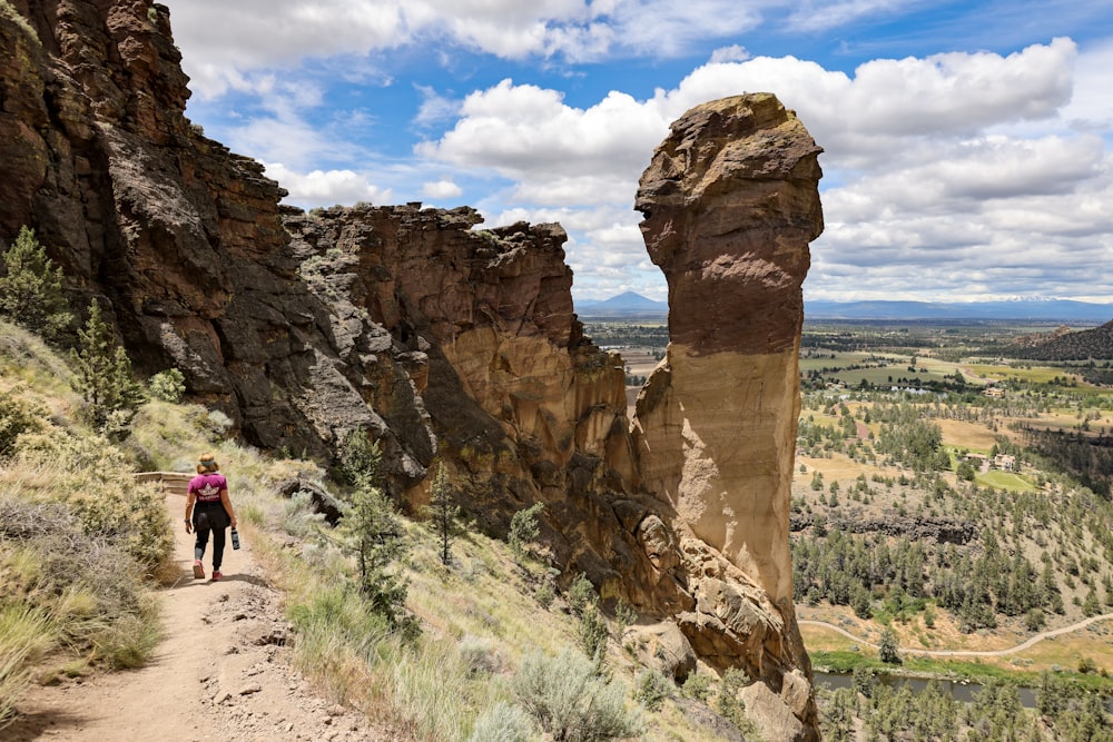 a person walking up a trail in the mountains