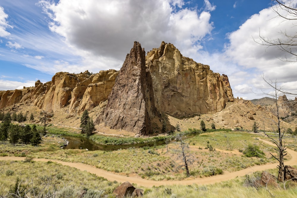 a large rock formation in the middle of a field