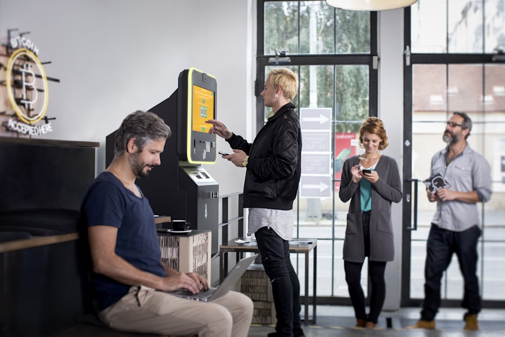 a group of people standing around a machine