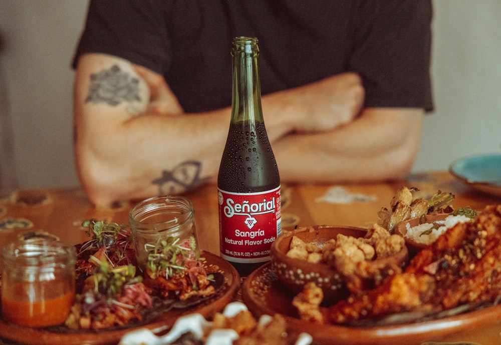 a bottle of beer sitting on top of a wooden table