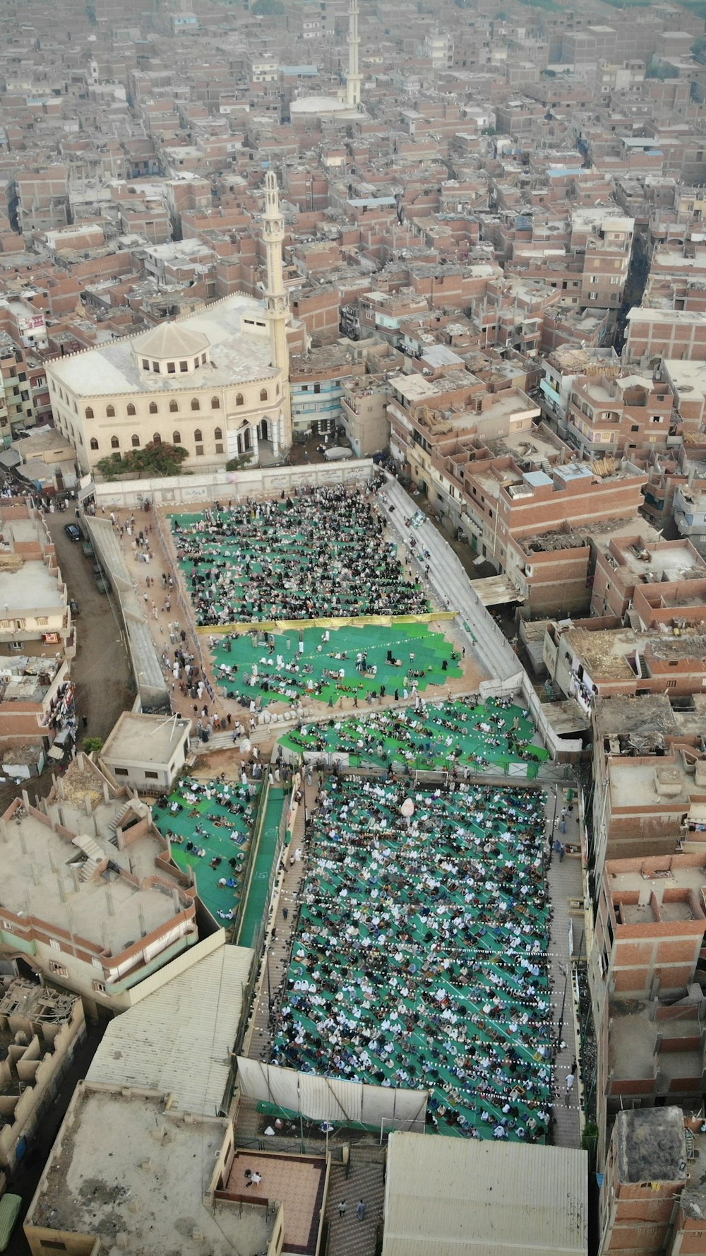 an aerial view of a large group of people in a city