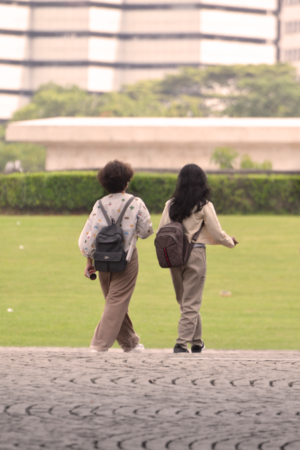 a couple of people that are standing in the grass