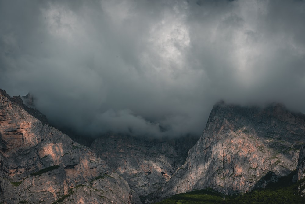 a mountain range under a cloudy sky