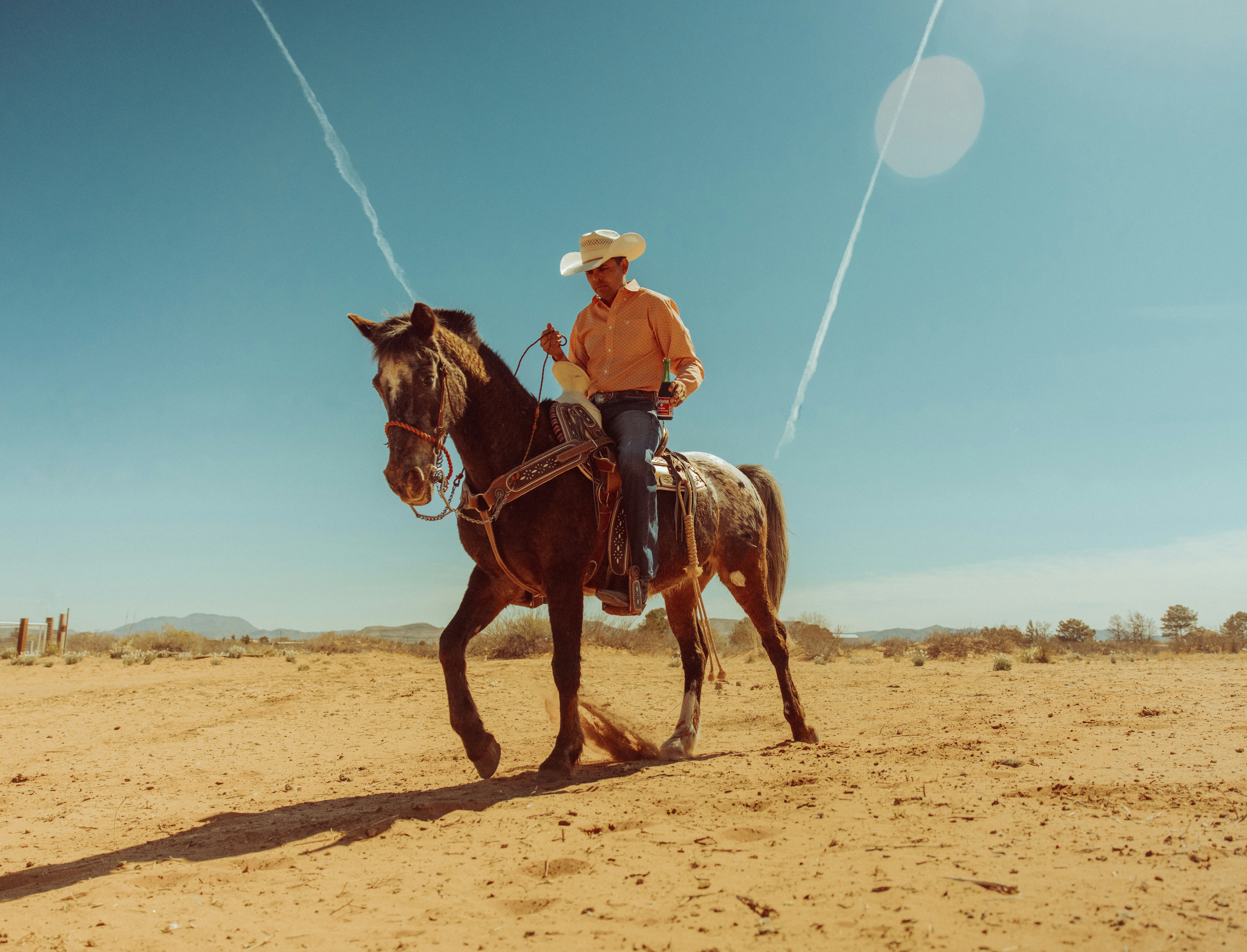 a man is riding a horse in the desert, 
